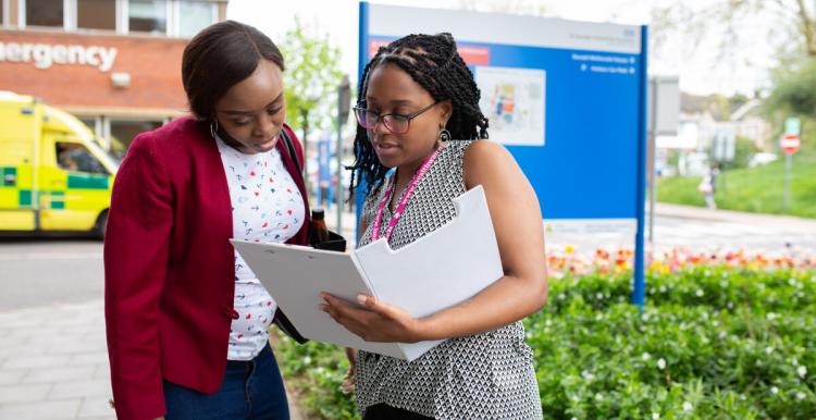 Two women looking at a file